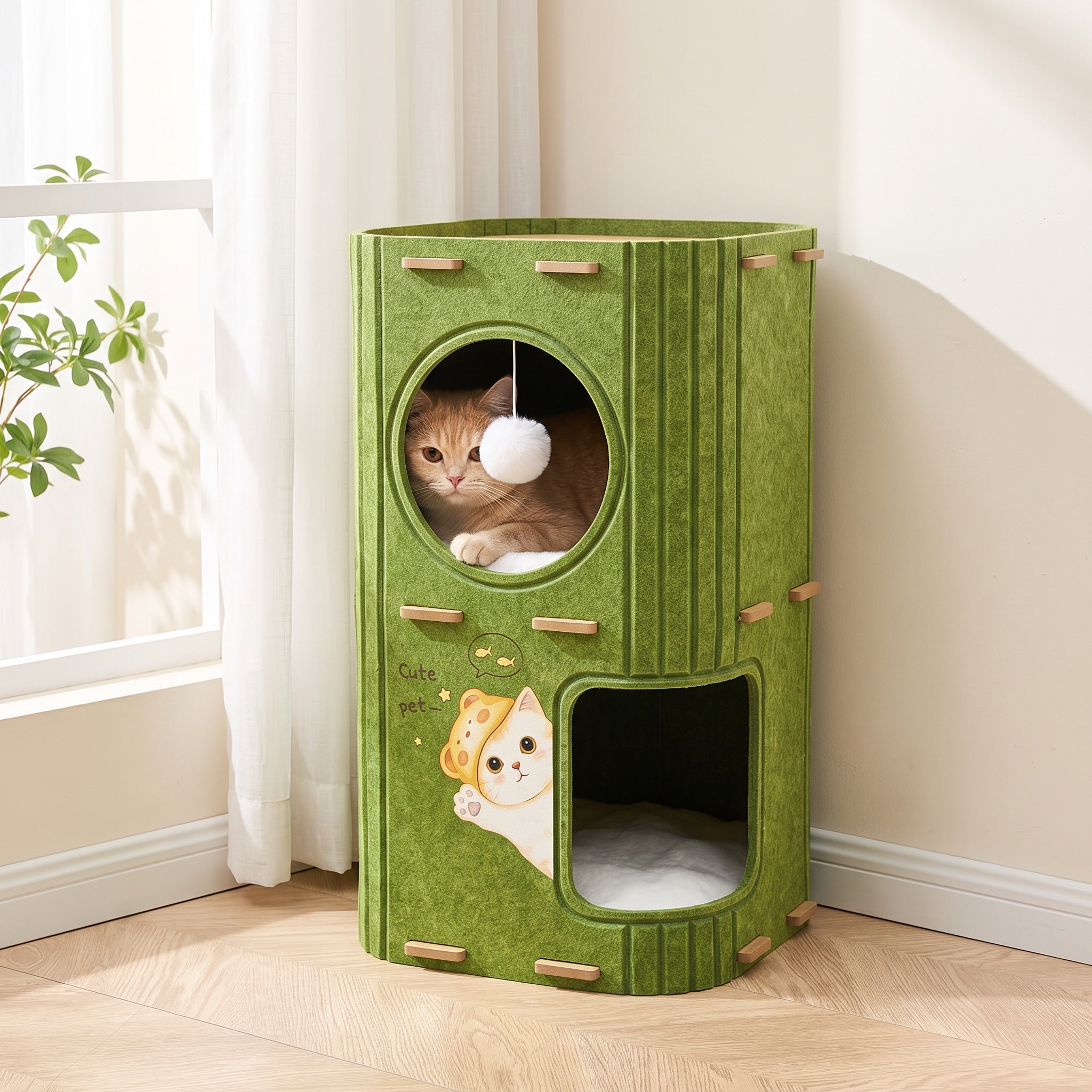 Orange tabby peeking from the round opening of a green felt cat tower, 24 inches tall