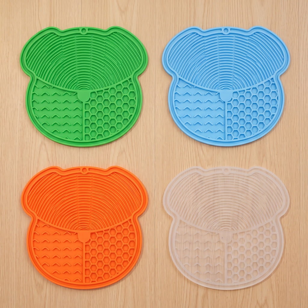 All four lick mat colors laid flat: green, blue, orange and transparent