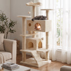 Two cats resting in the condos and platforms of a beige cat tree by a bright window