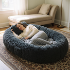 Woman asleep under a knit blanket in the dark grey CalmCurl Den
