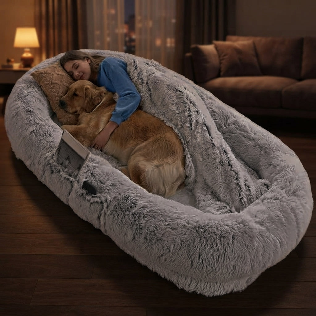 Person and golden retriever asleep together in the CalmCurl human dog bed at night