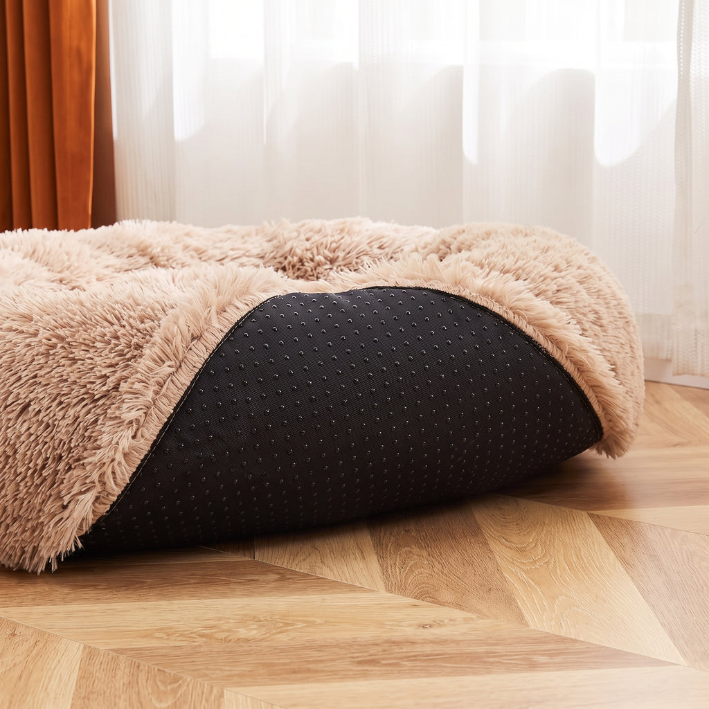 CalmCurl bed edge lifted showing the black non-slip dotted waterproof base